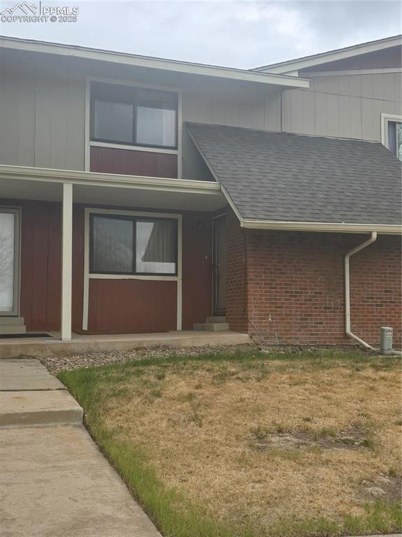 View of front of home featuring brick siding, a fr