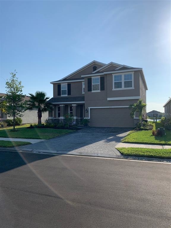 Welcome Home! Front of house with paver drive and 