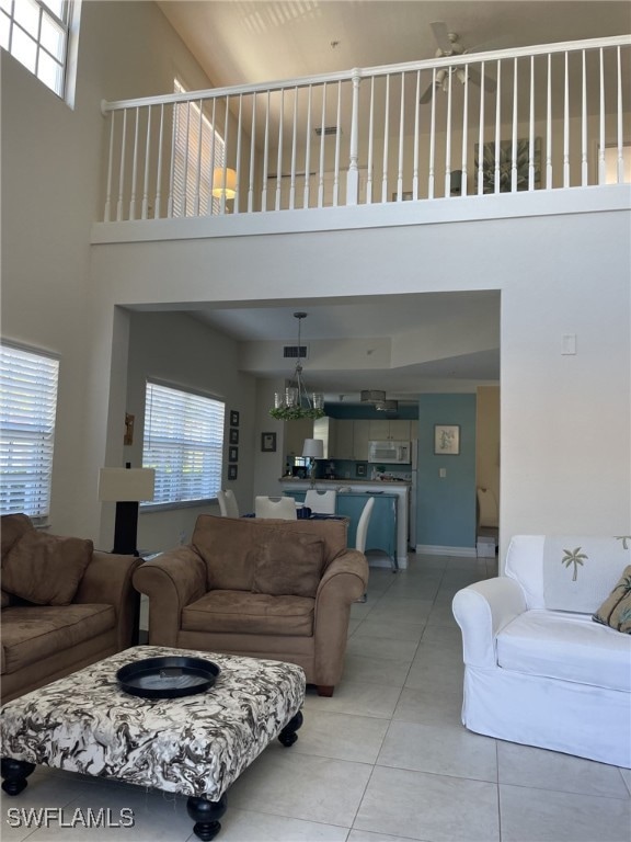 Living room with light tile patterned floors, plen