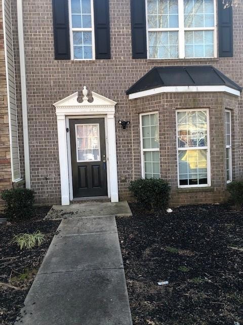 View of exterior entry with brick siding