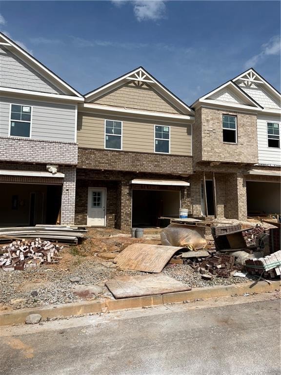 View of property with brick siding
