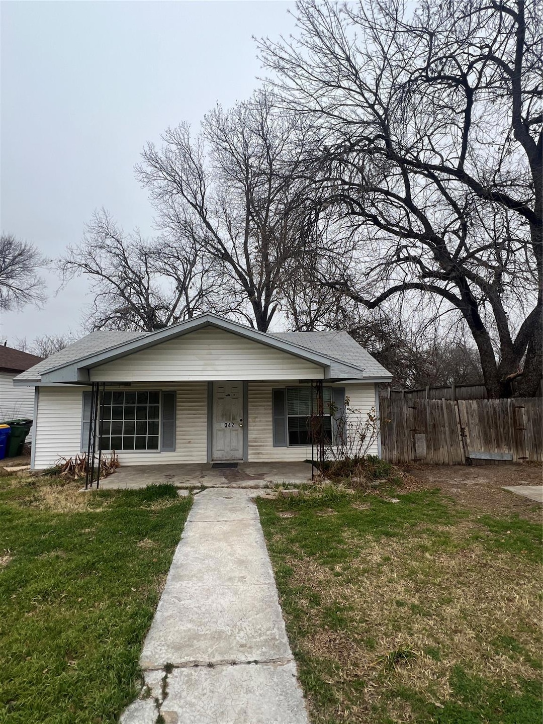 Bungalow with a front lawn and a porch