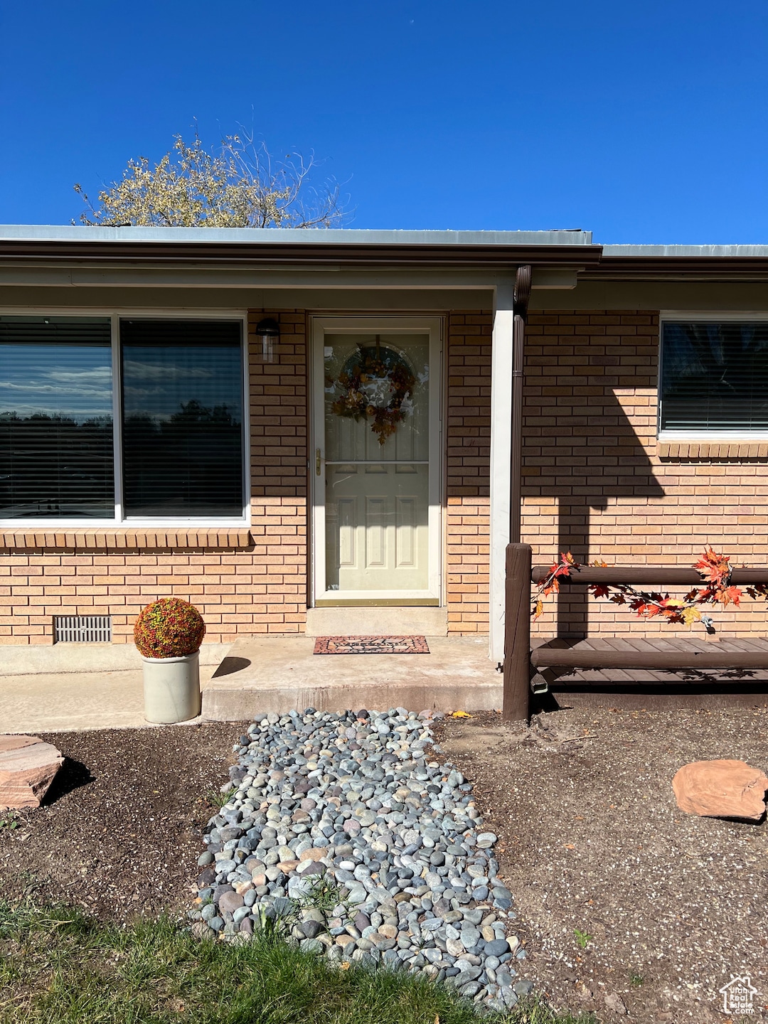 Doorway to property featuring brick siding