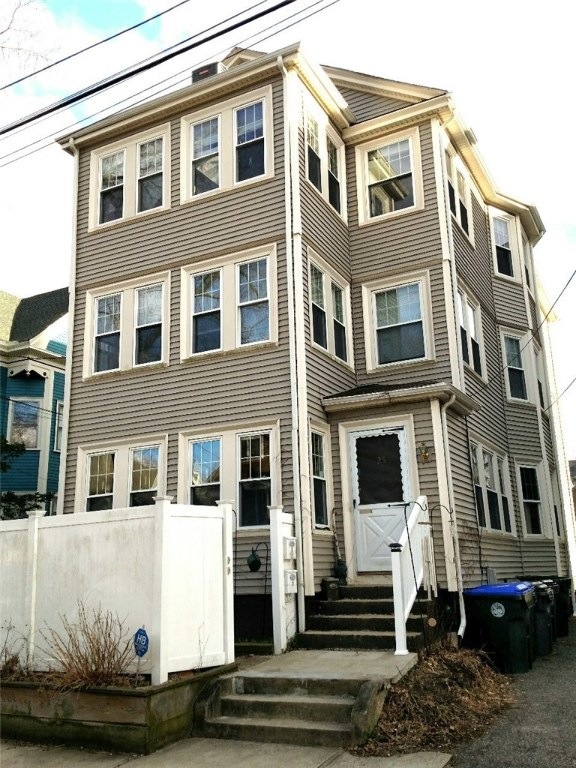 Front view, fenced sitting/garden area in front.