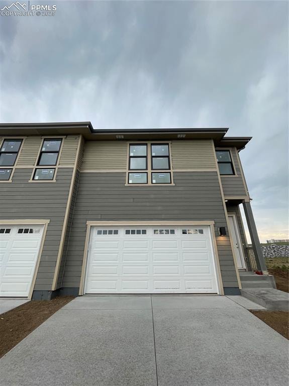 View of front of house featuring a garage and driveway