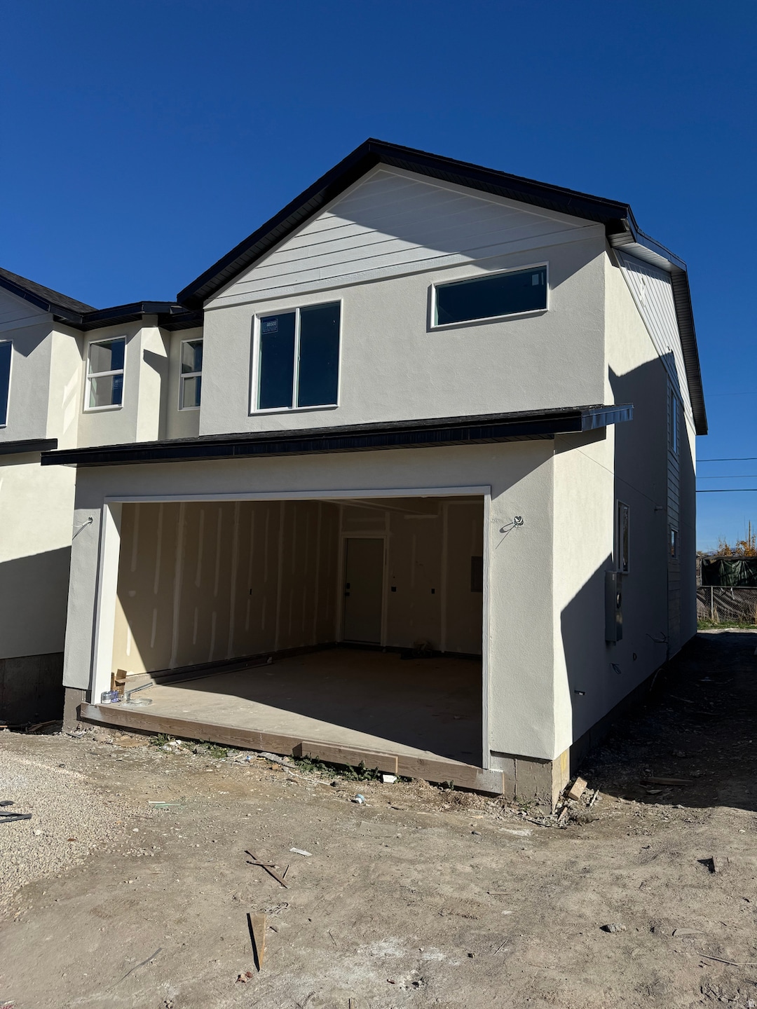 View of front of property featuring stucco siding and a garage