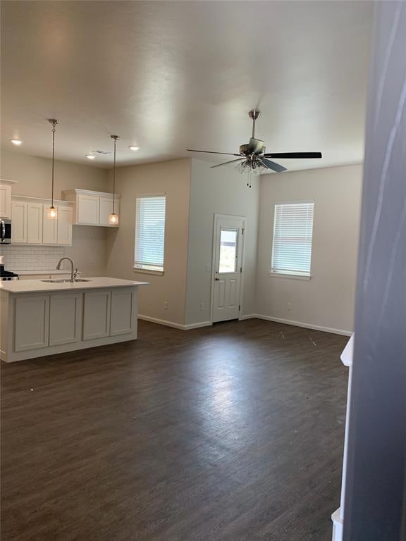 Unfurnished living room with dark wood-style floor