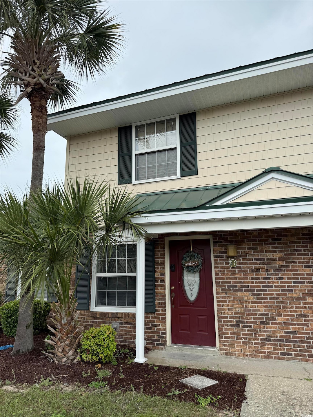 Property entrance featuring brick siding