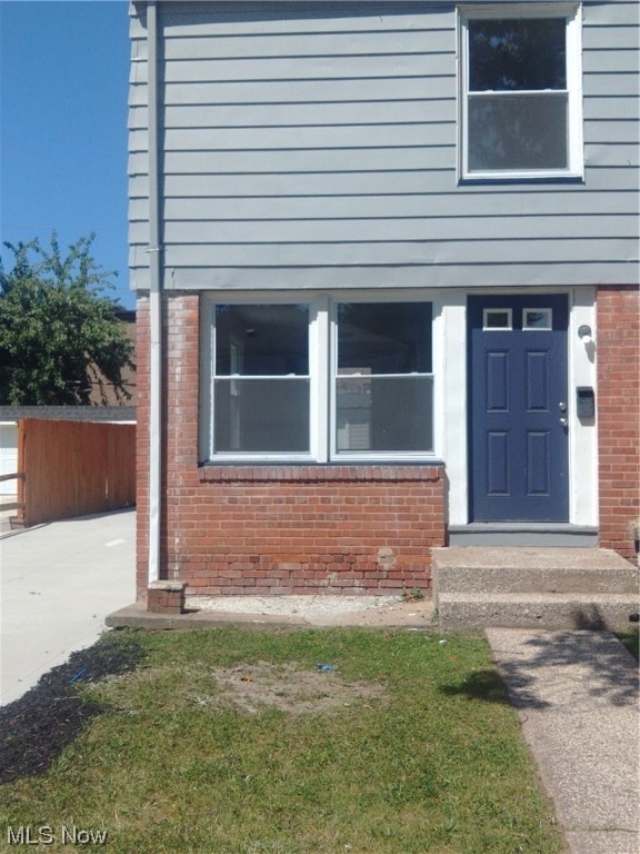 Entrance to property with a lawn