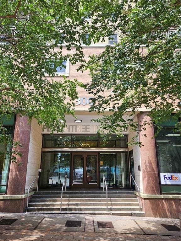 Doorway to property featuring french doors and brick siding