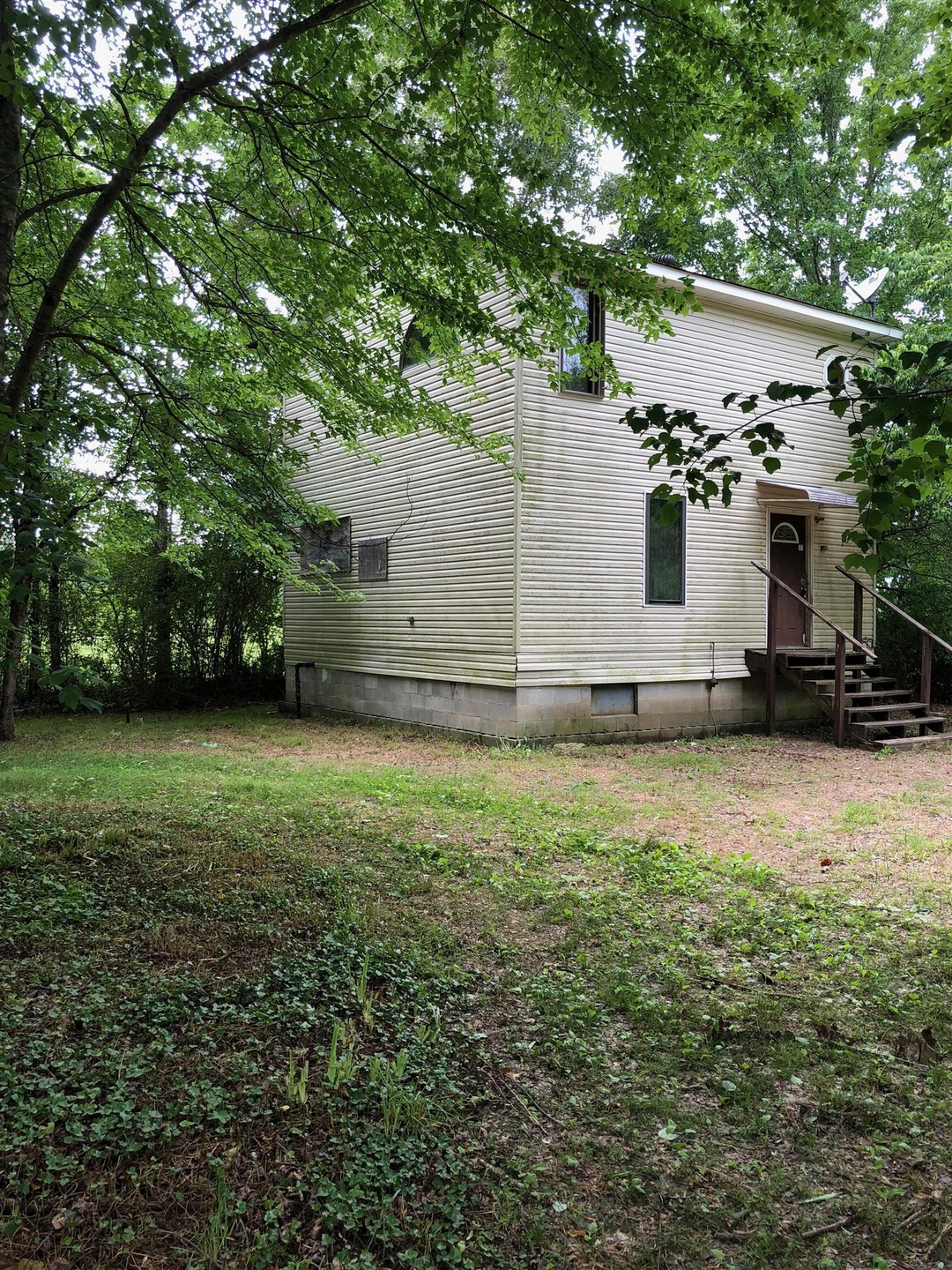 Two story cottage at 50 Kelton Rd on .68 acre. 