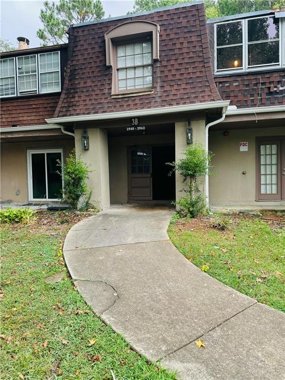 Entrance to property featuring a lawn