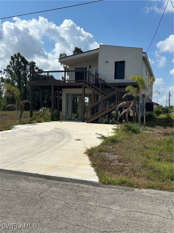 View of front of house featuring stucco siding, dr