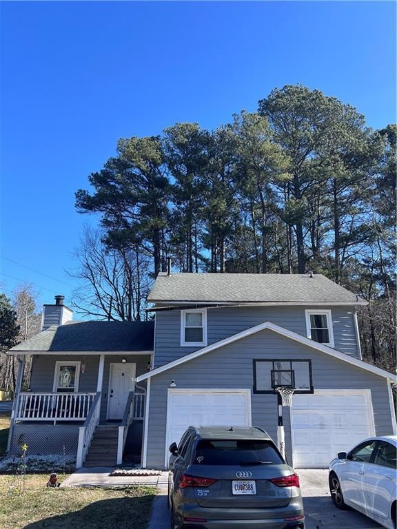 Split level home featuring concrete driveway, a ch
