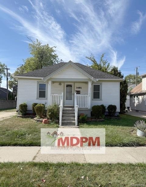 Bungalow-style house featuring a front lawn and covered porch