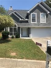 View of front of home featuring a garage and a front lawn