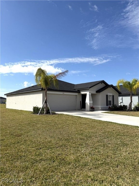 View of side of home with a lawn, driveway, an attached garage, and stucco siding