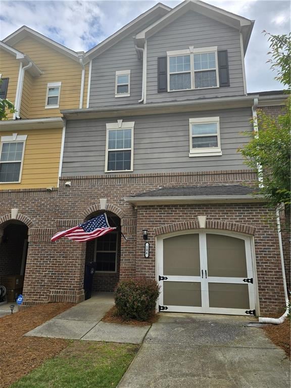 Multi unit property with driveway, brick siding, a