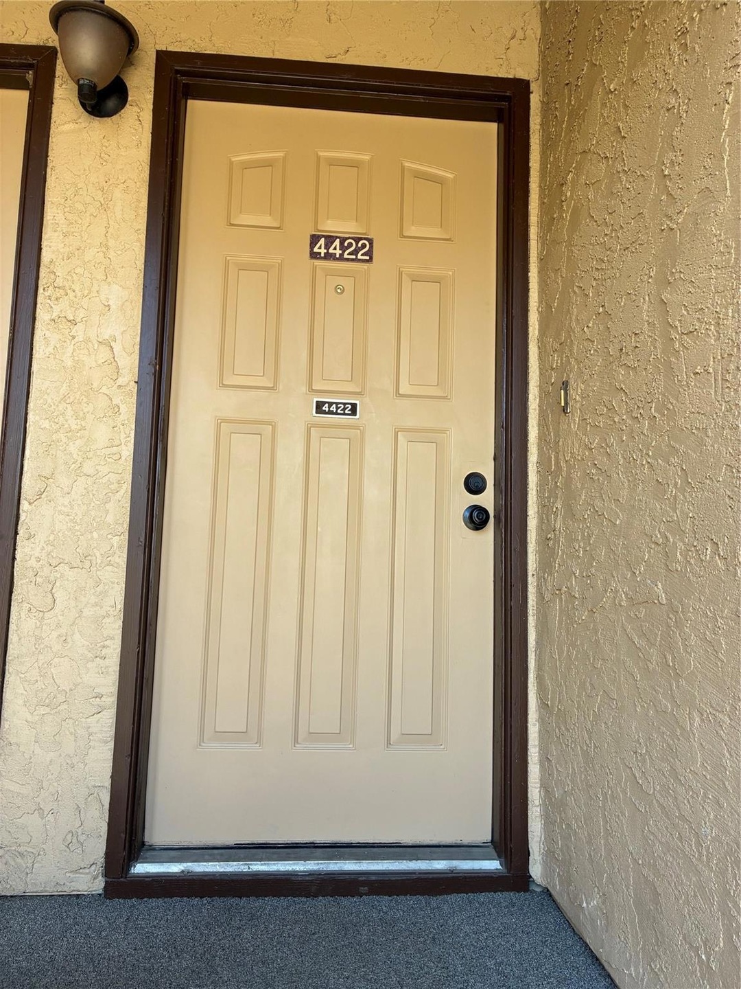 Property entrance featuring stucco siding
