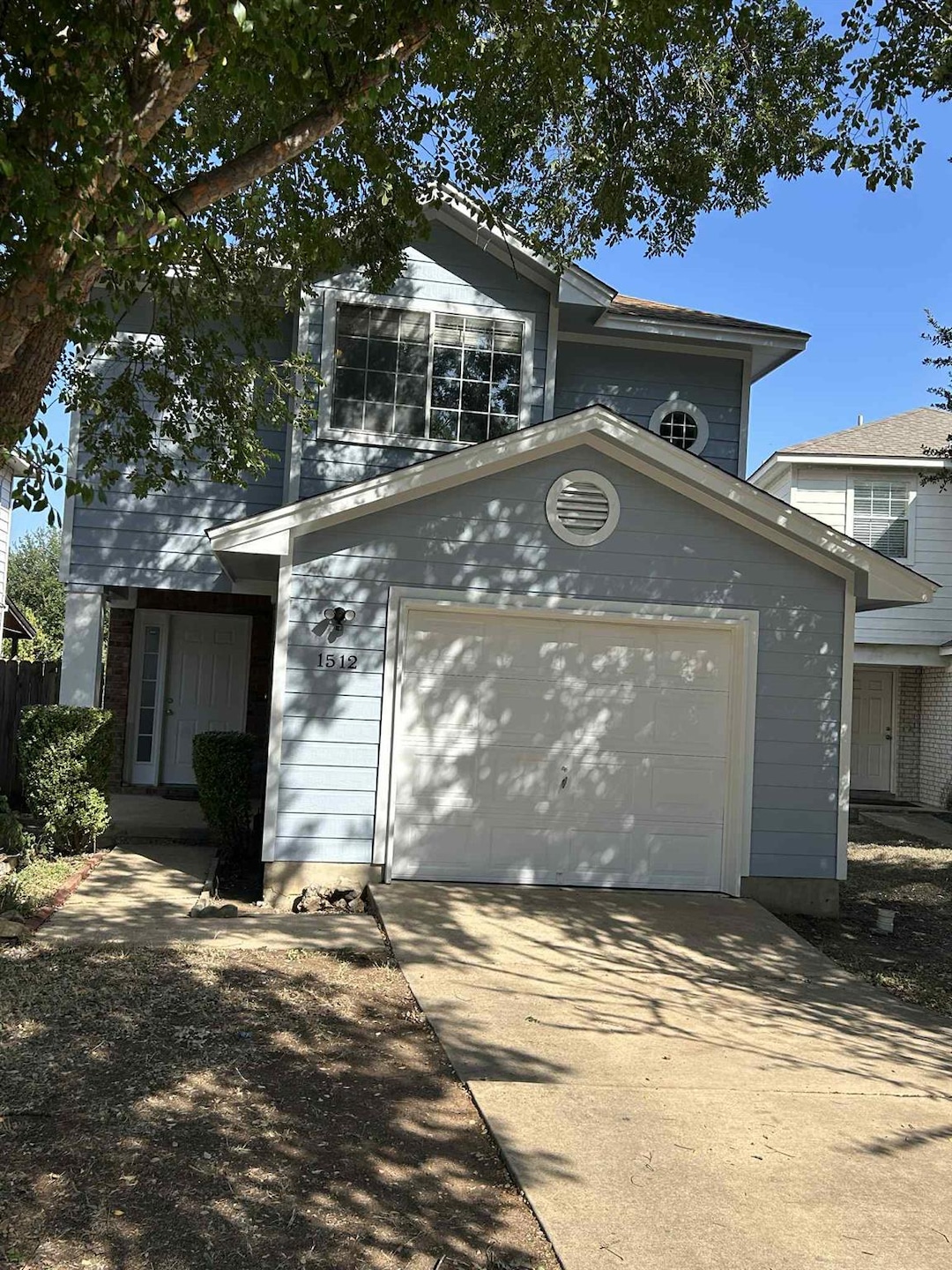 View of front of home with driveway and an attached garage