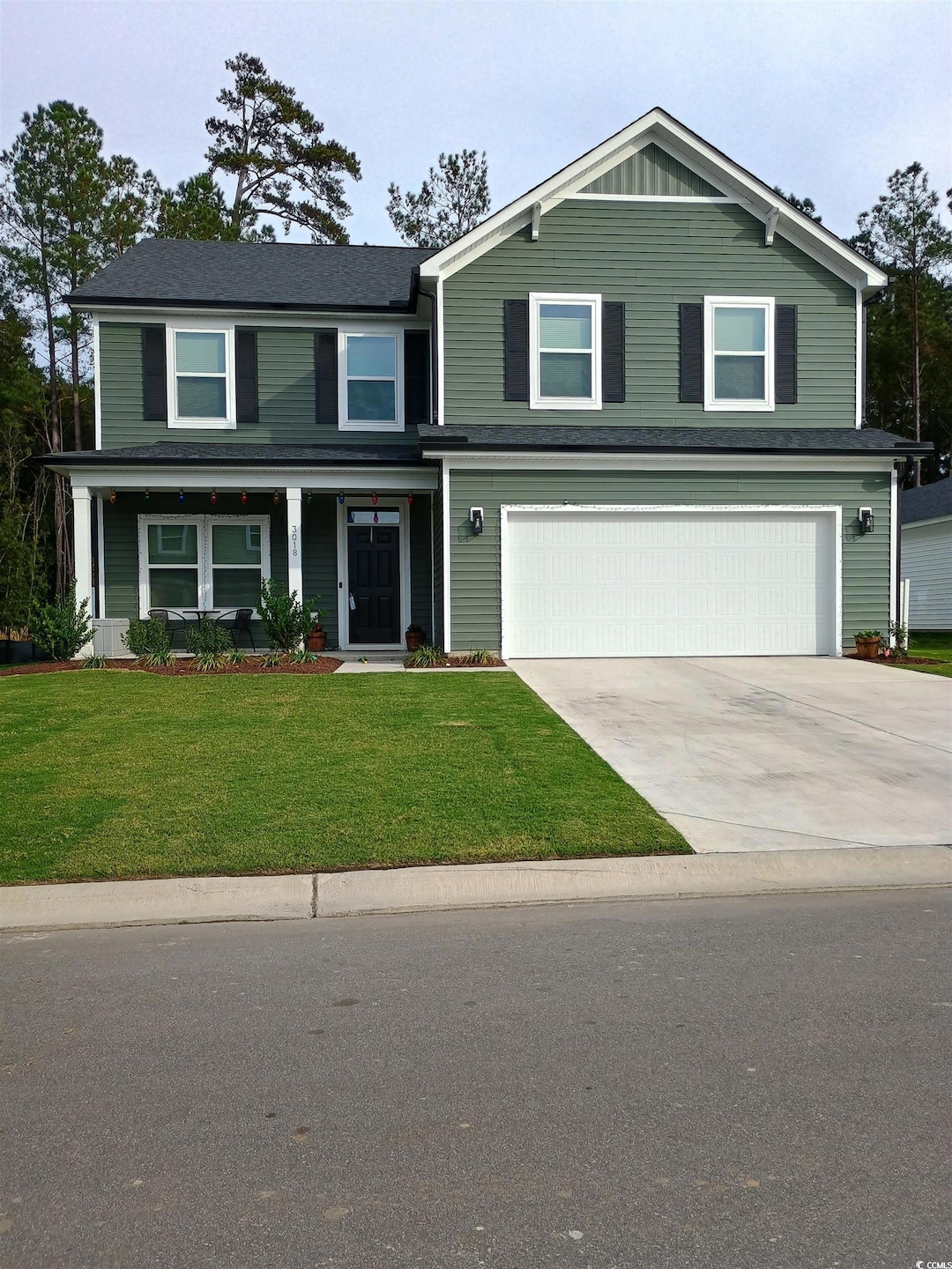 Front of property with a front yard and a garage