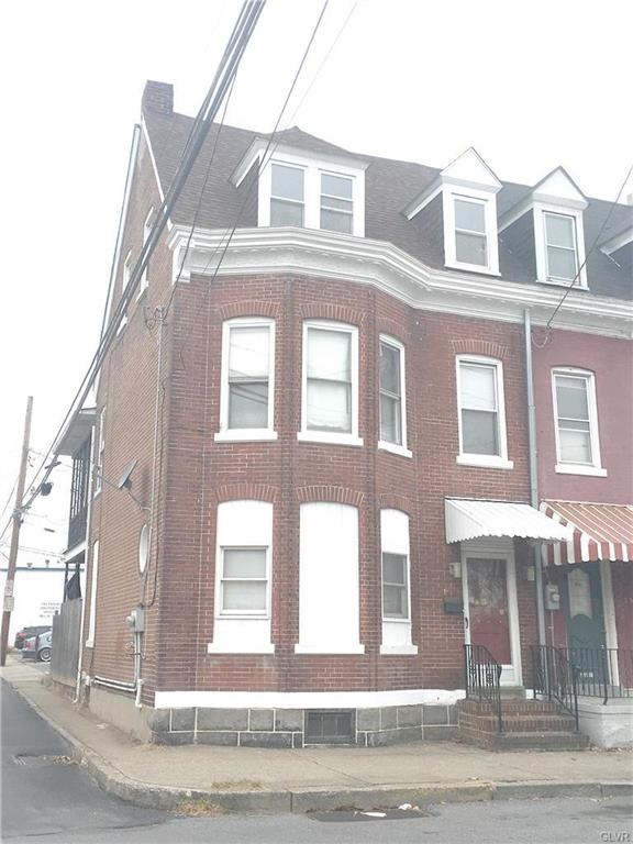 Handsome brick home at the end of the row.