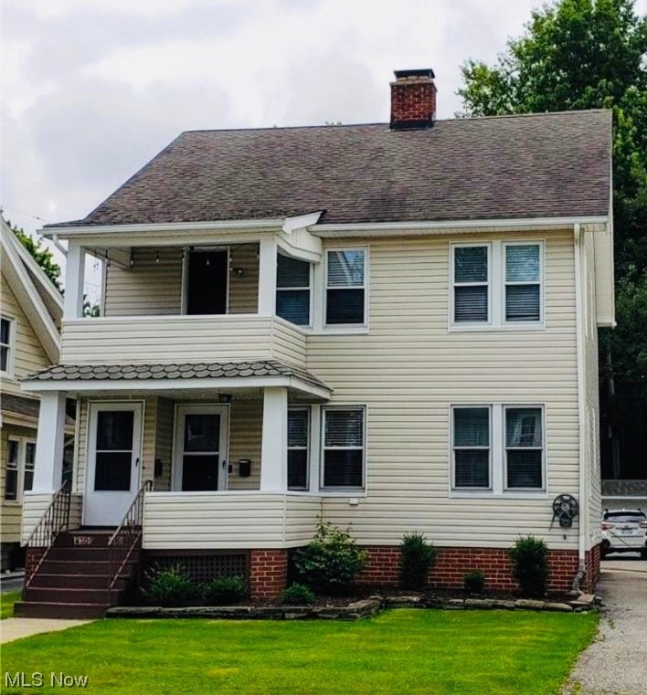 View of front of house with a front lawn and a porch