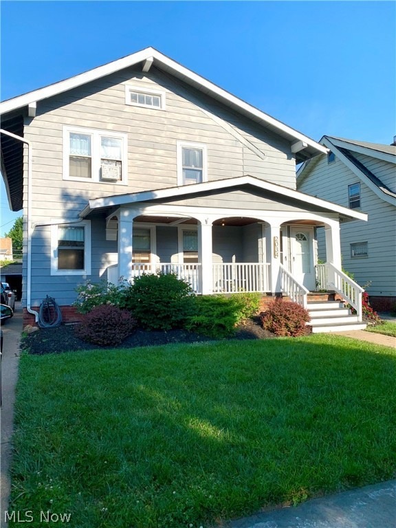 View of front facade with a front lawn and a porch