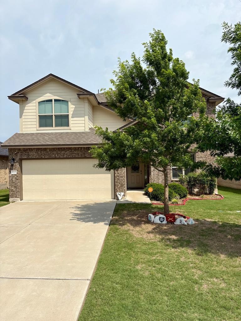 View of front of property featuring roof with shi