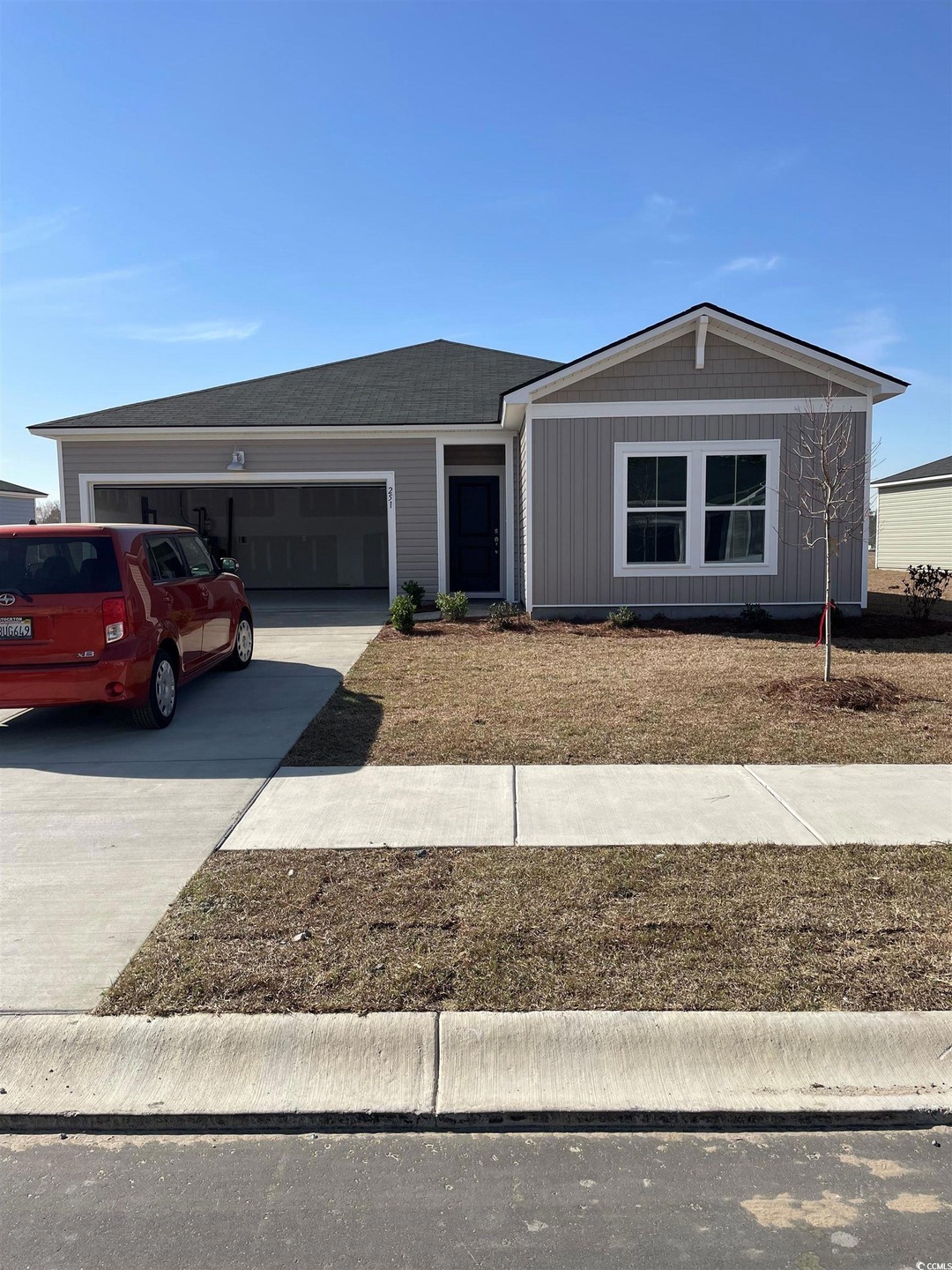 Ranch-style house with concrete driveway and an at