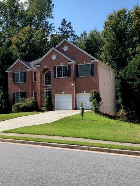 View of front facade featuring a garage and a fron