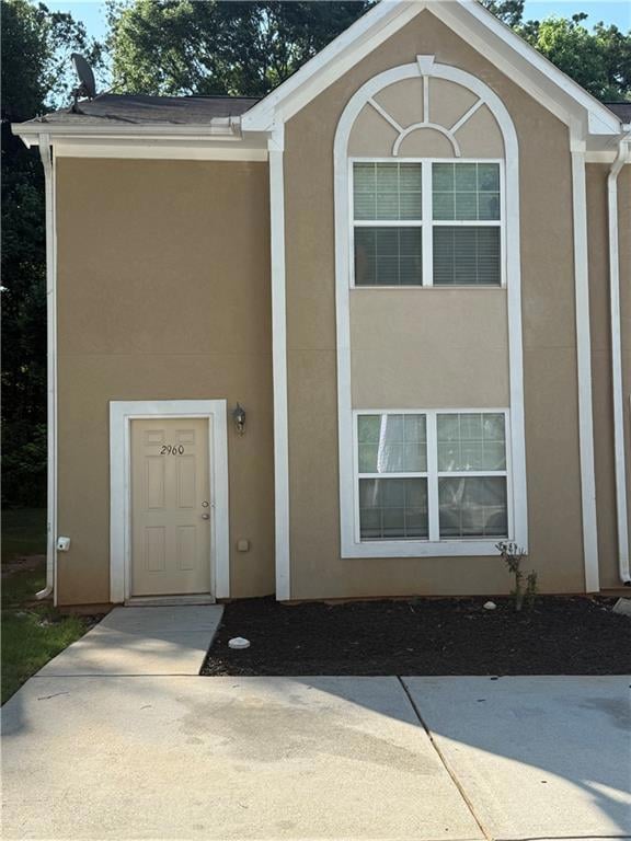 Property entrance with stucco siding