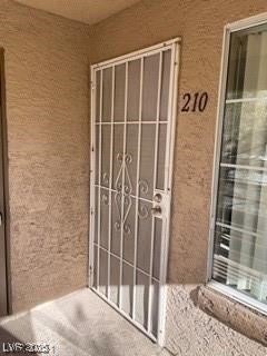 Doorway to property with stucco siding