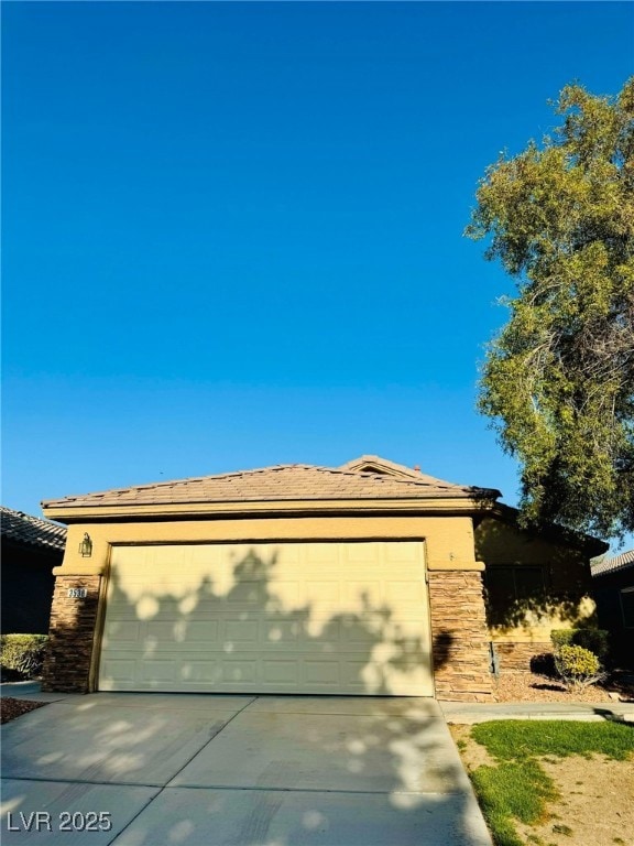 Prairie-style home with concrete driveway, stucco