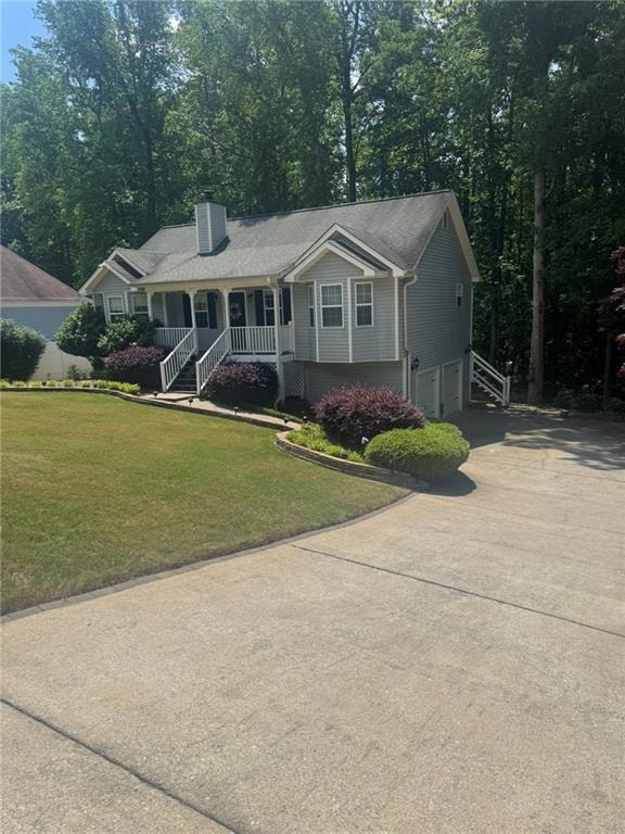 Ranch-style house featuring a garage, covered porch, concrete driveway, a chimney, and a front lawn