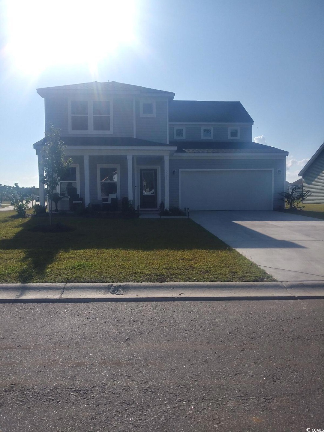 View of front facade featuring a garage, a front l