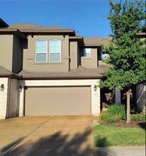 View of front facade with driveway, an attached g