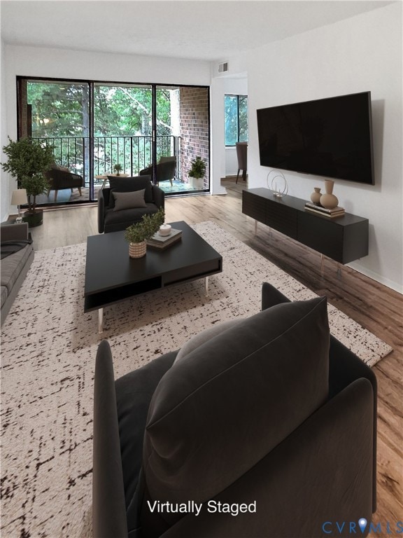 Living area with wood-style floors and balcony access