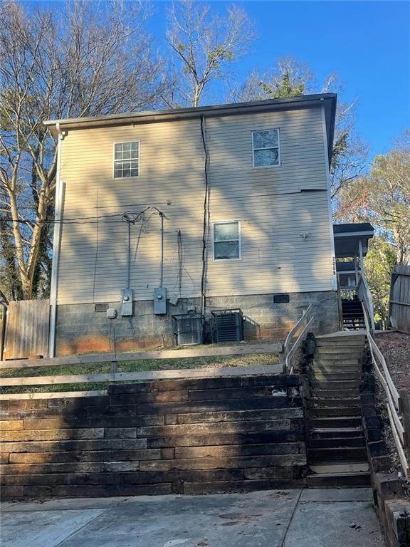 Back of house featuring central AC unit