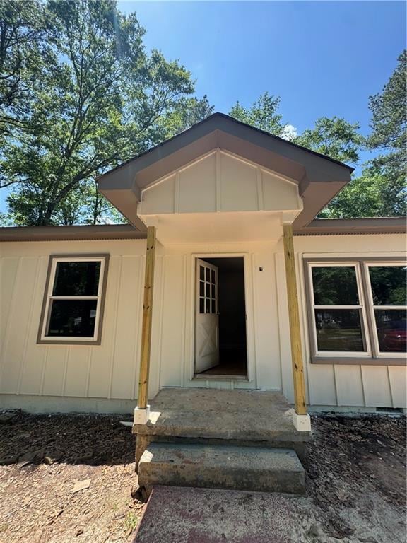 Property entrance featuring board and batten siding