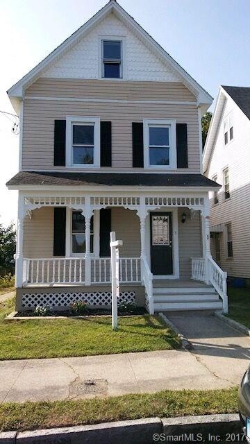Front of home. Front porch with classic railings a