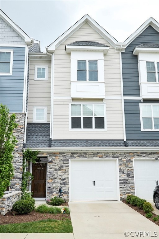 Townhome / multi-family property featuring a garag