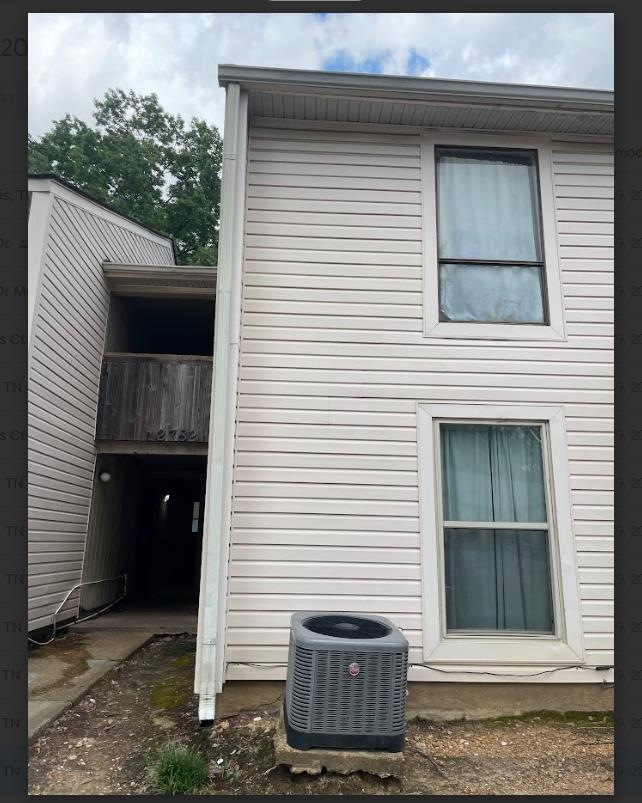 View of side of home with a central air condition unit