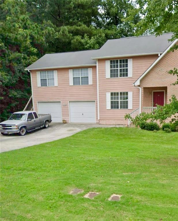 View of front of property featuring driveway, a fr