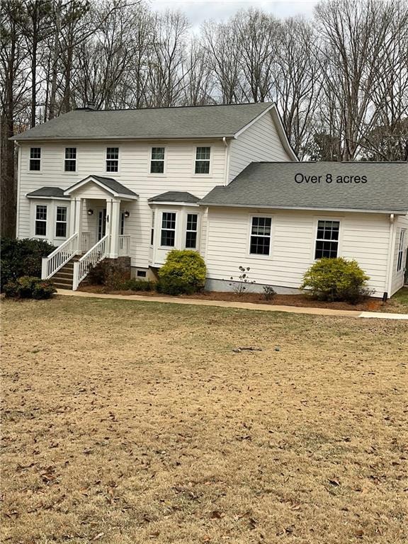 View of front facade with crawl space and roof wit