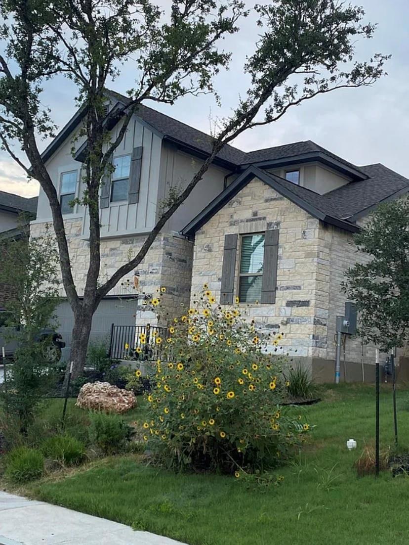 View of front of property featuring stone siding,