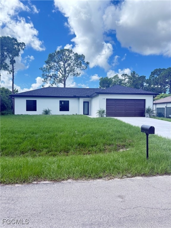 Single story home with a garage, concrete driveway, stucco siding, a front lawn, and roof with shingles