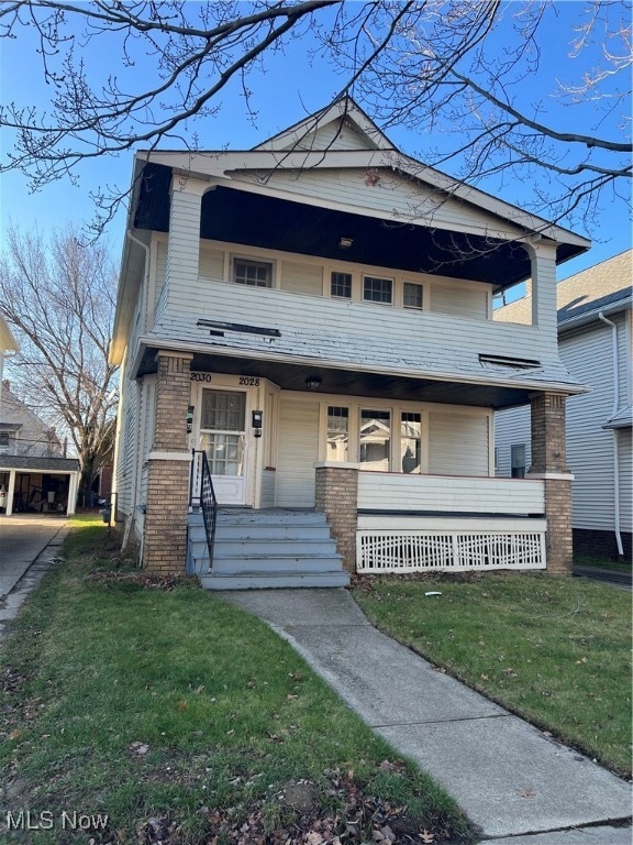 View of front of home featuring a porch and a front yard
