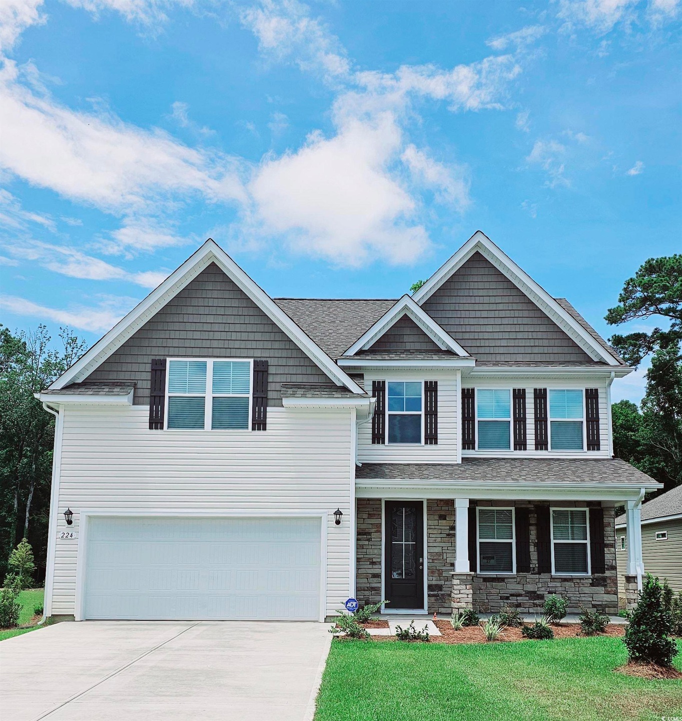 Craftsman inspired home with a garage and a front 