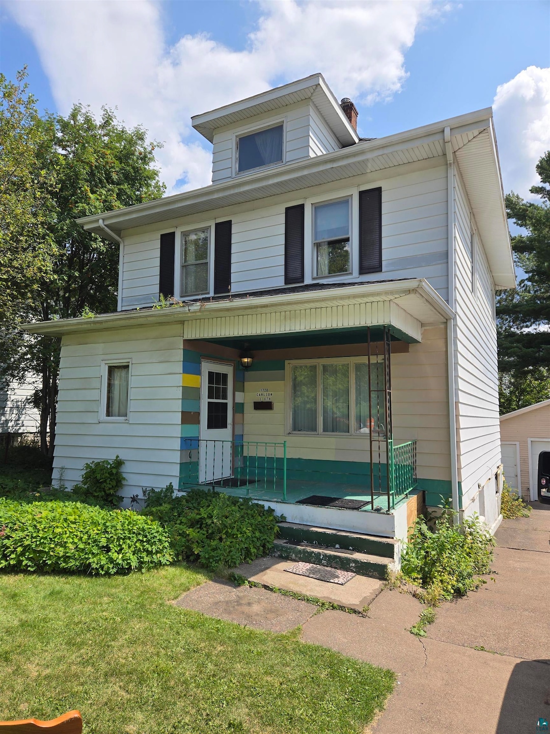 Front facade featuring a garage, a porch, and a fr